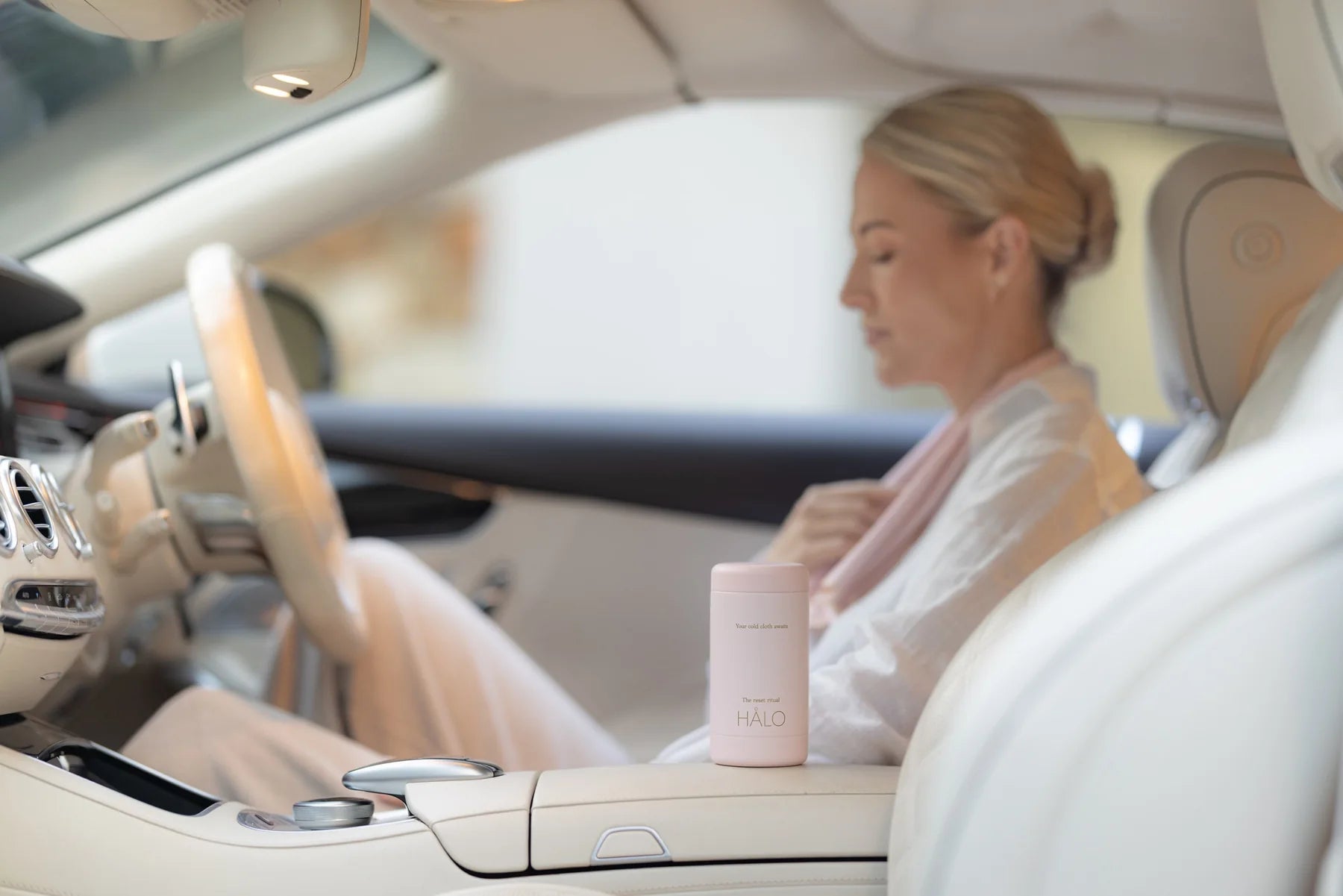 A woman taking a cooling pause in her car